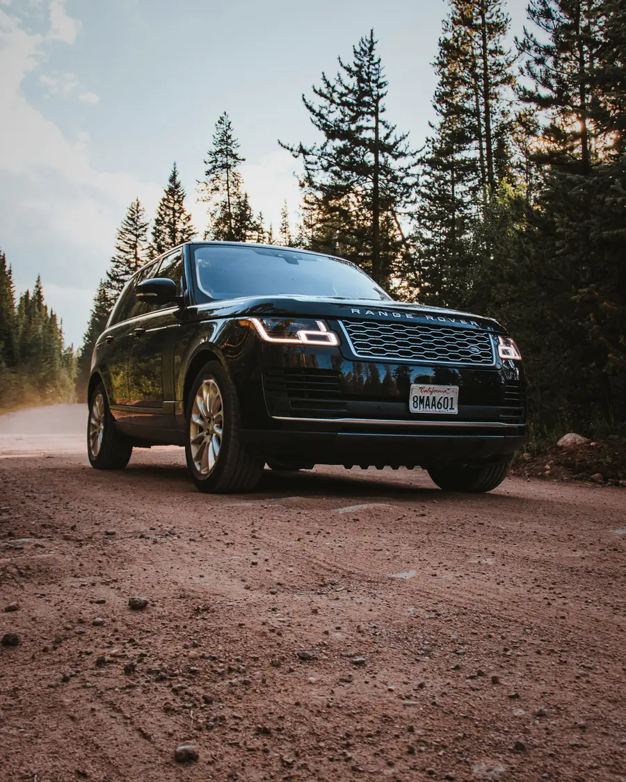 Range Rover on a sandy road by the sea, dark grey